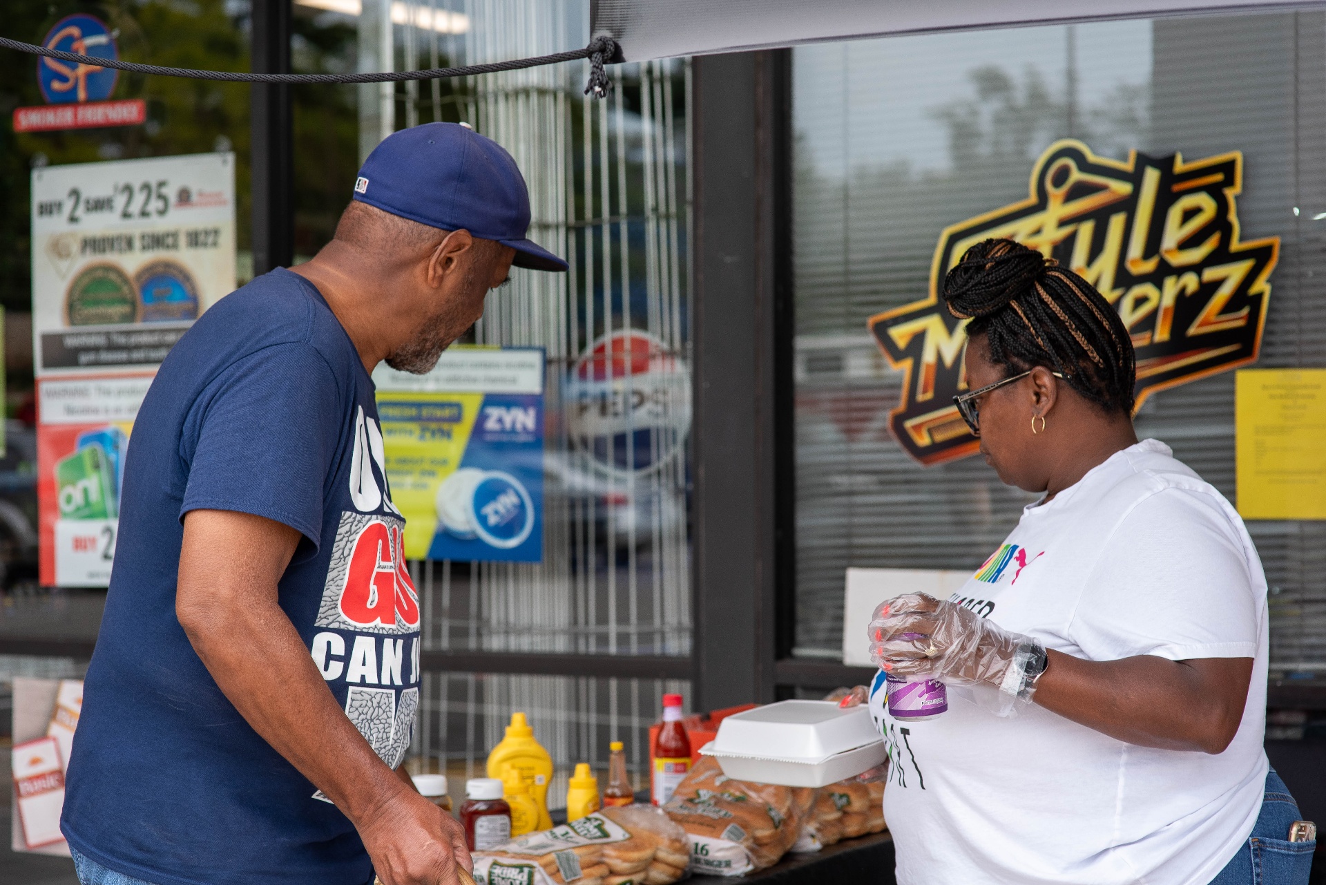 Serving food to guests at the Back to School Bash