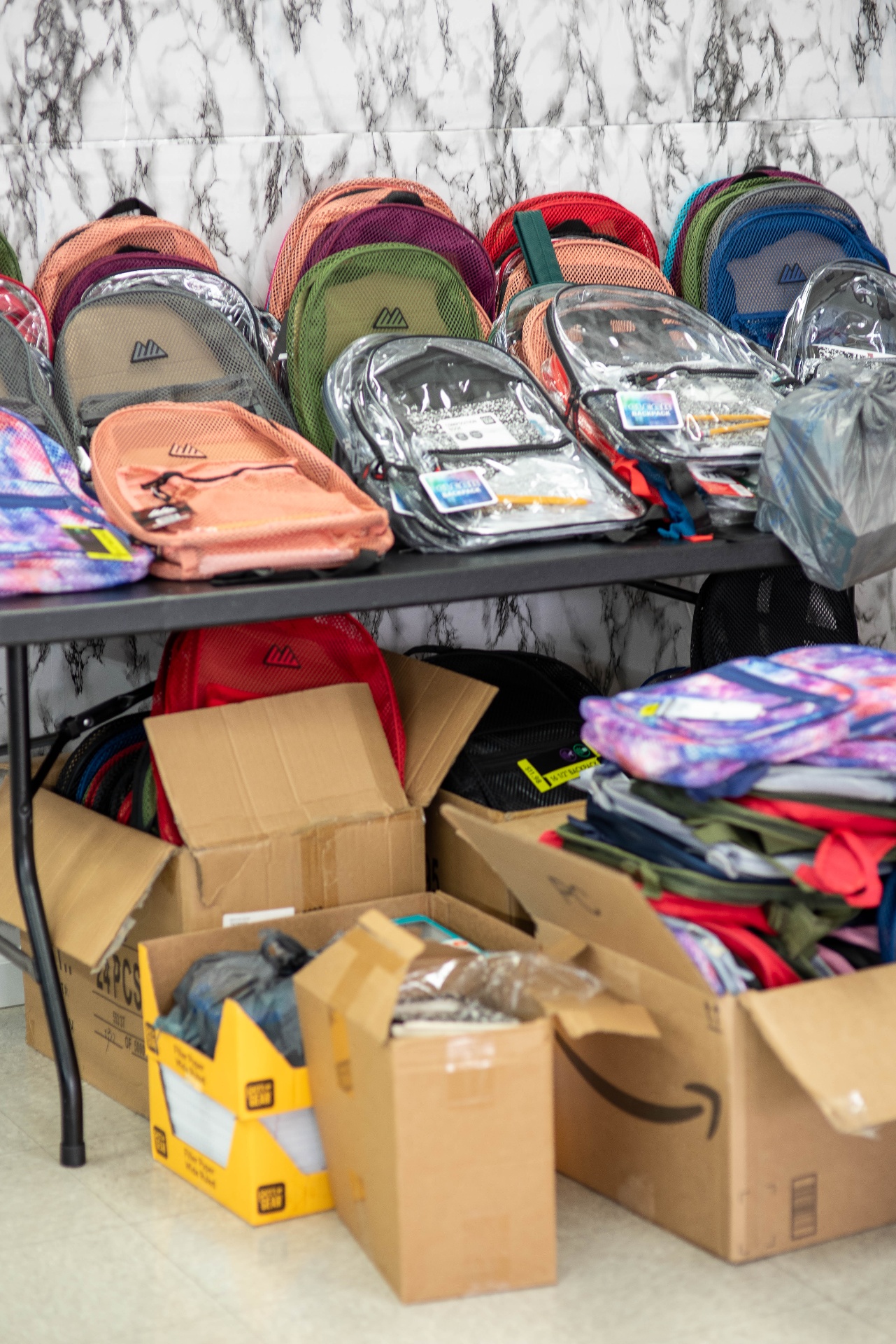Stacks of backpacks and school supplies ready for pickup