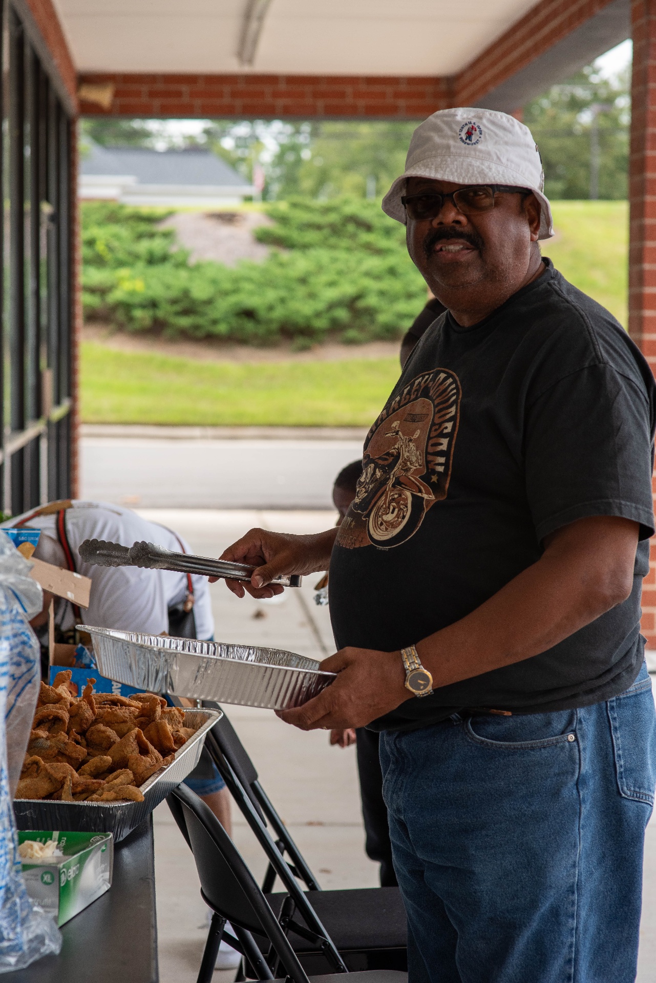 Cookout volunteer holding a serving tray for families