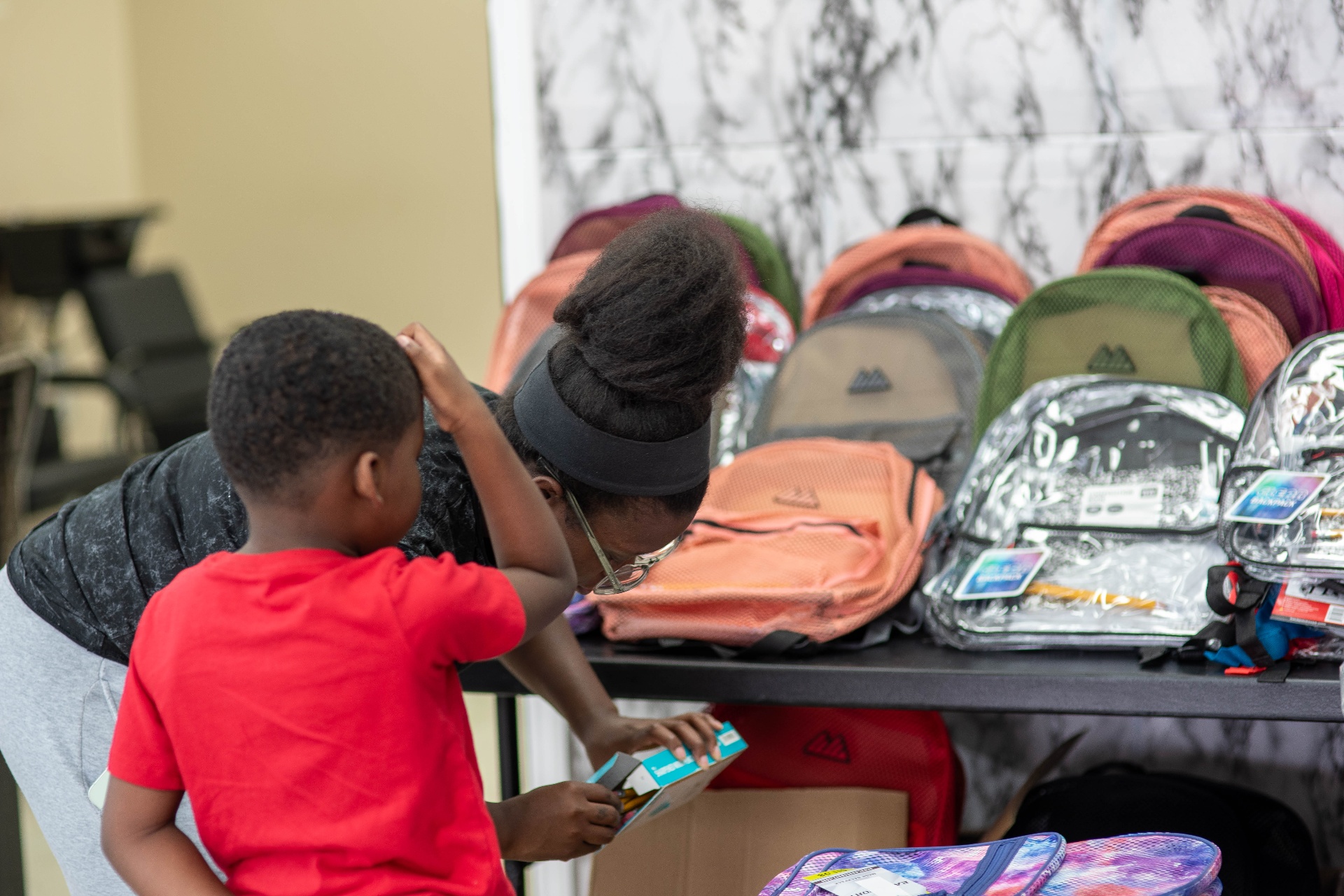 Family picking out a backpack and supplies
