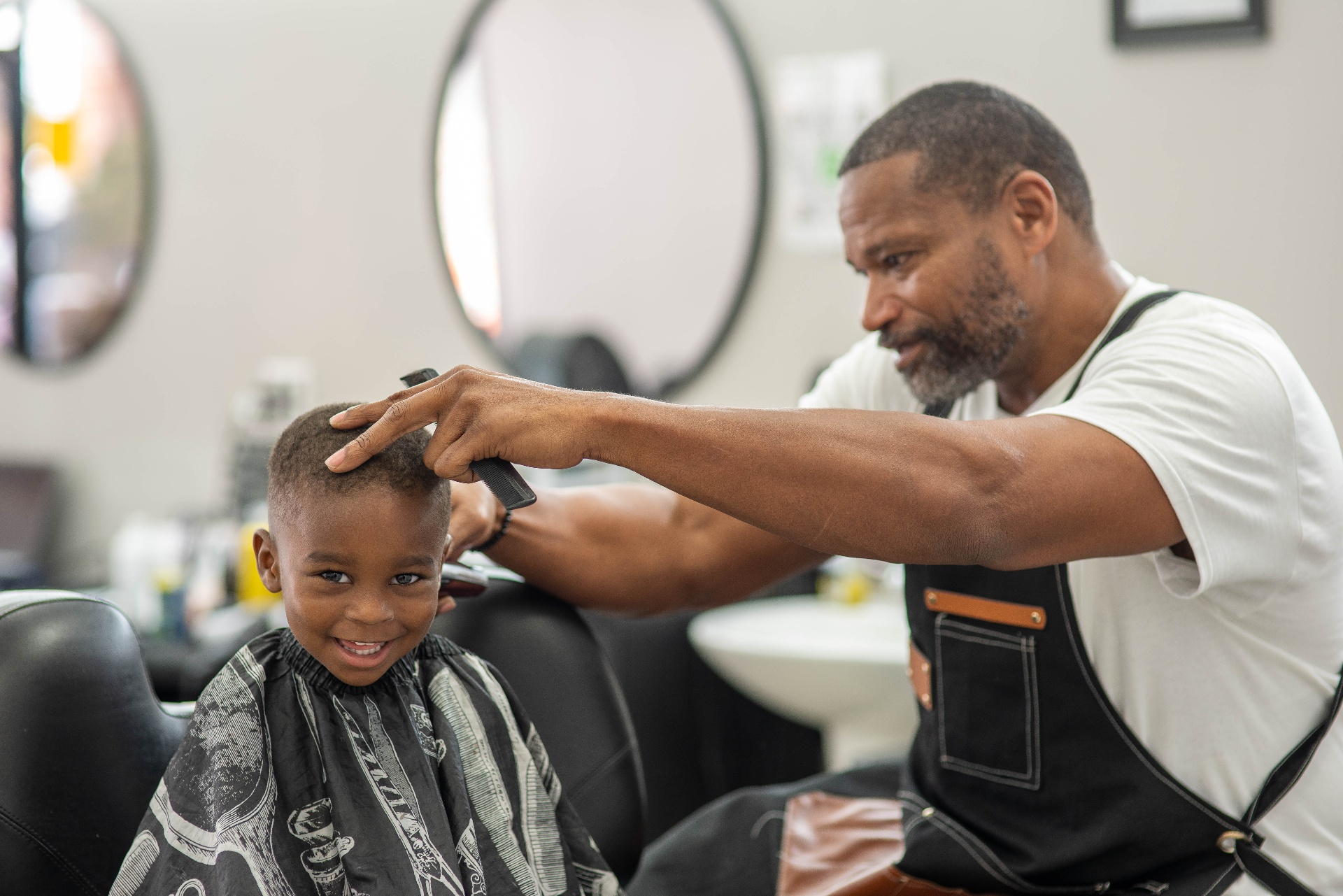 Young client smiling after a fresh fade at Style Masterz