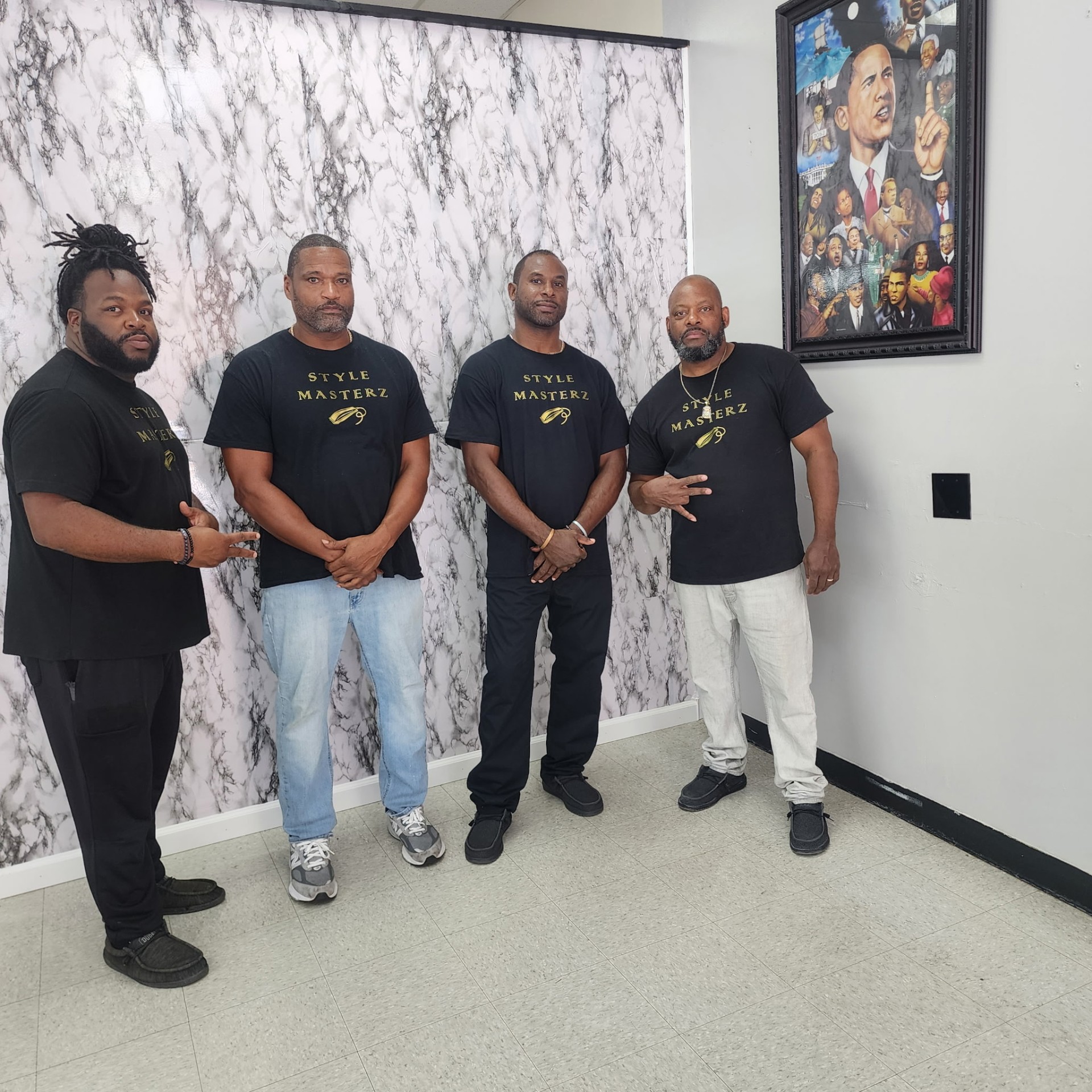 Style Masterz barbers in branded gold tees