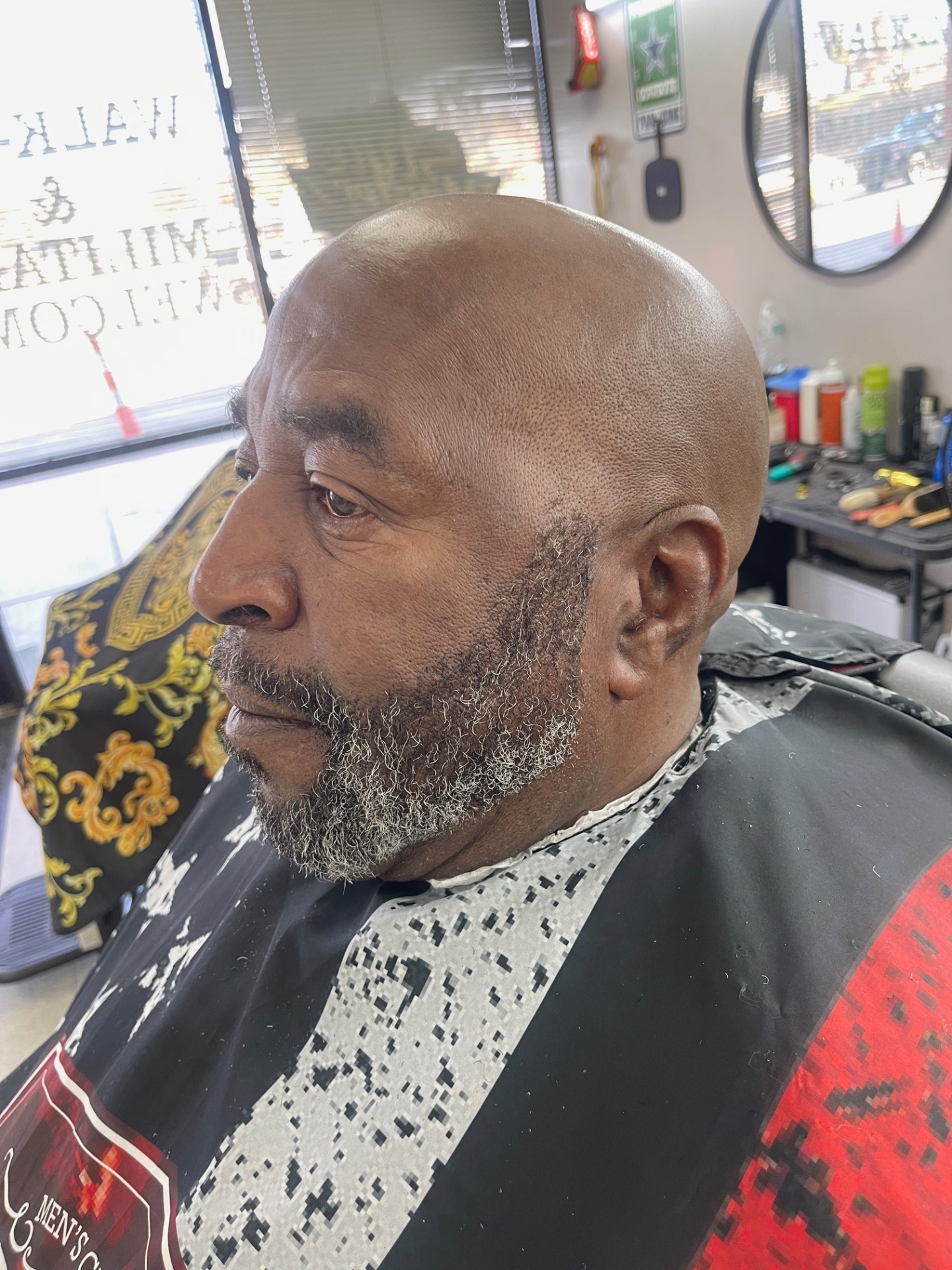 Bald head with sculpted salt-and-pepper beard