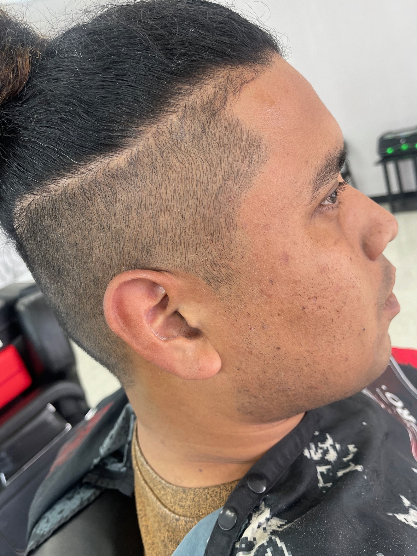 Man bun with high skin fade