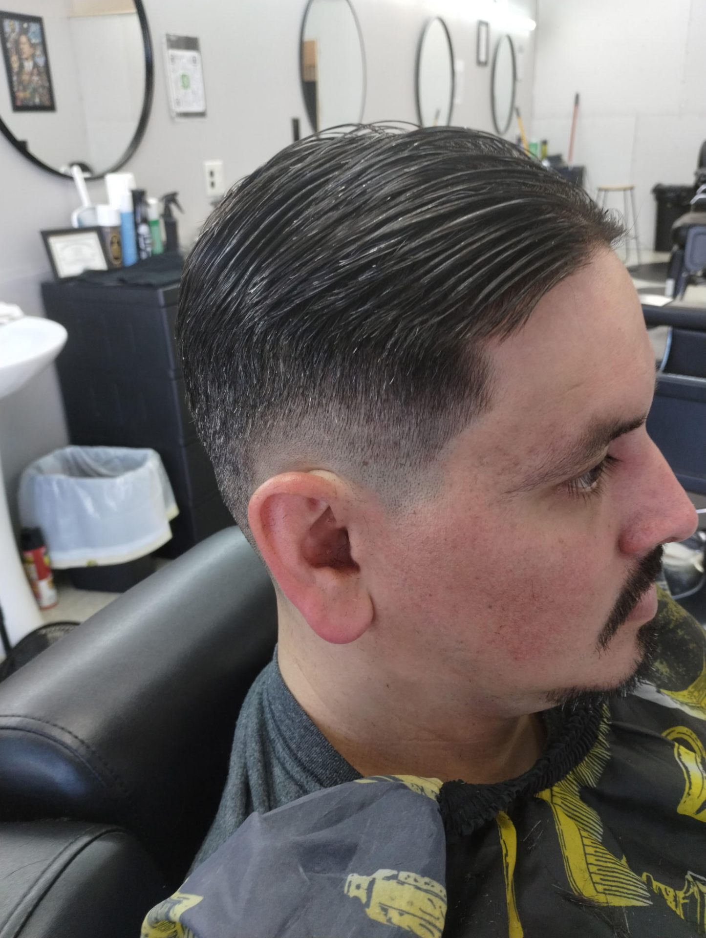 Classic slick back with mid skin fade