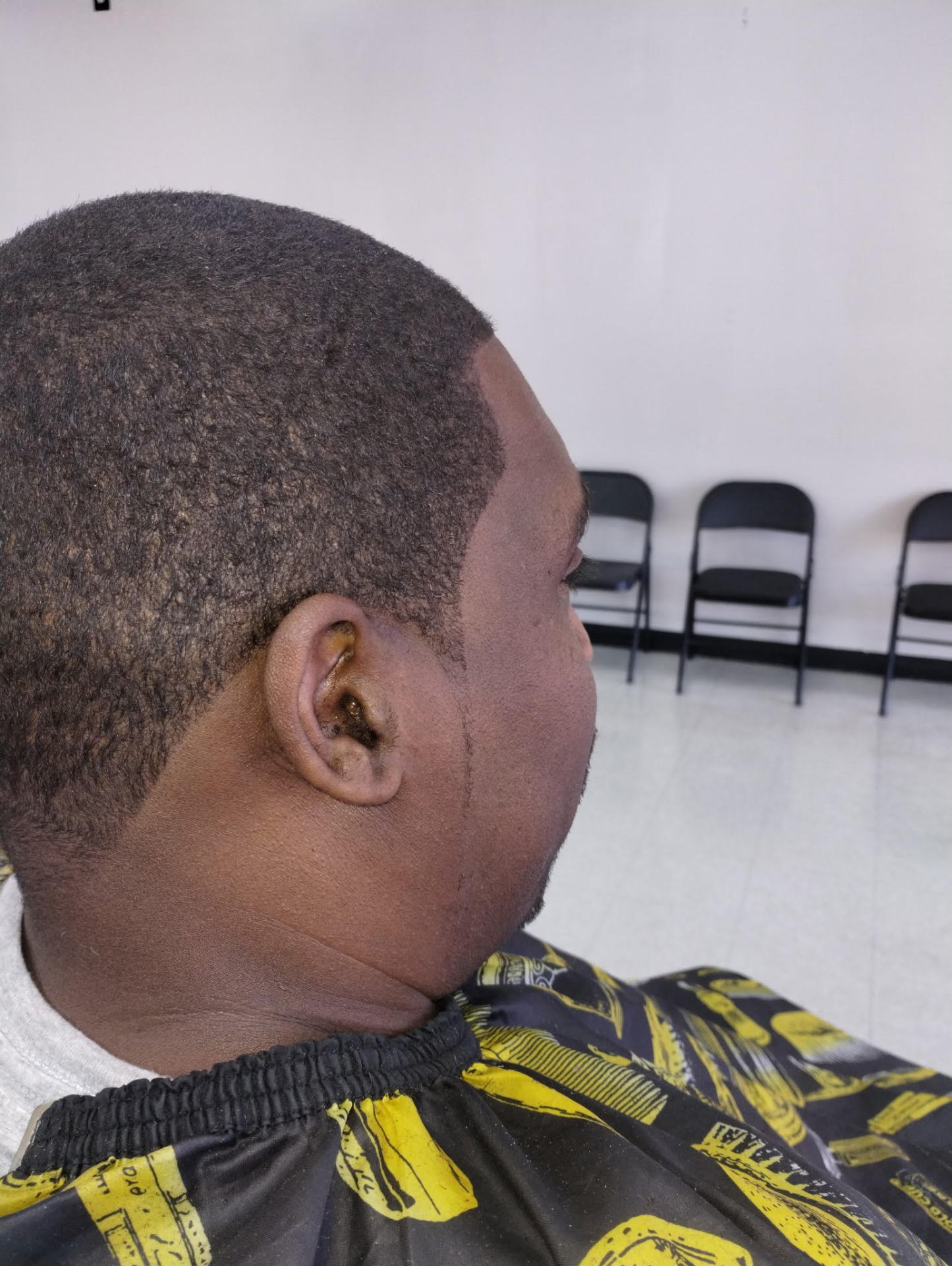 Smooth buzz cut with sculpted edge up